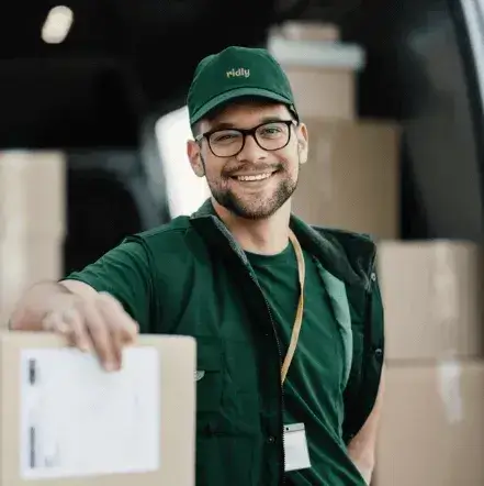 Ridly worker smiling in front of loaded truck